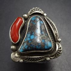 VINTAGE INDIAN MOUNTAIN TURQUOISE and RED MEDITERRANEAN CORAL STERLING SILVER  RING DESCRIPTION: With breathtaking specimens of natural Indian Mountain turquoise and red Mediterranean coral, this ring will be a treasured addition to your collection of fine vintage Southwestern and Native American jewelry. MEASUREMENTS:  Ring face measures 1 1/4" x 1" RING SIZE: 9 1/2 (adjustable) WEIGHT: 13.4 grams SIGNED: LB (Navajo) STERLING: yes, stamped 925 Jewelry Measurements, Adjustable Weights, Vintage Indian, Coral Turquoise, American Jewelry, Native American Jewelry, Rings Statement, Sterling Silber, Sterling Silver Ring