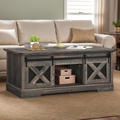 a living room with a couch, coffee table and other items on the carpeted floor