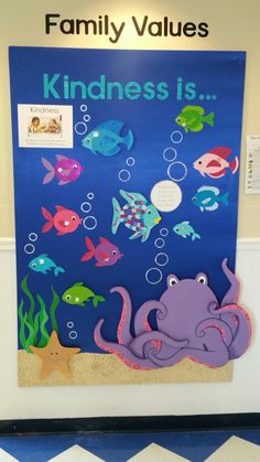 a bulletin board with an octopus, fish and sea life on it's side