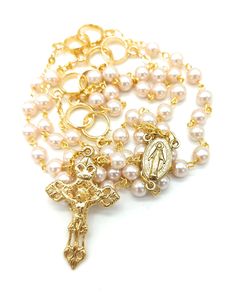 Handmade wedding rosary length 46 cm (18.11''). Rosary of the bride and groom. Rosary with symbol of wedding rings. MADE IN ITALY Ideal to give as a wedding anniversary gift or to future newlyweds. The length also allows it to be worn on the wedding day. Pearl-effect waxed glass beads, gold metal binding and Miraculous medal. Rosary for good luck.  RETURNS AND REFUNDS: Our products are handcrafted and may differ slightly from the photos in the listing. If you are not satisfied with the product y White Miraculous Medal Necklace For Wedding, Elegant Adjustable Crucifix Rosary, Elegant Adjustable Rosary With Crucifix, Adjustable Elegant Crucifix Rosary, Spiritual Crucifix Jewelry For Wedding, Spiritual Crucifix Necklace For Wedding, Elegant Gold Rosary For Anniversary, Elegant Gold Anniversary Rosary, Elegant Adjustable Rosary