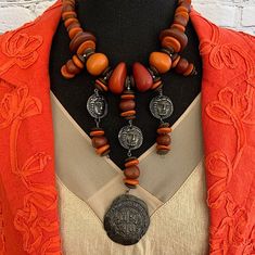 "Beautiful Vintage Les Bernard Spanish Cob Statement 1960's Necklace. Pewter Coin Replicas. Large Beads of  Brown and Orange with 4.5\" Bib Station. Necklace measures 17\" Excellent preowned condition. Minimal wear marks consistent with age and storage. Les Bernard designs were used for the stars in \"Dynasty \"" Vintage Necklaces With Wooden Beads, Vintage Polished Beads Necklaces, Vintage Style Polished Beads Necklace, Vintage Orange Necklace With Wooden Beads, Art Nouveau Necklaces, Large Beads, Brown And Orange, Unusual Jewelry, Vintage Bell