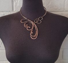 Handcrafted antique copper open necklace with bare copper wire. Hammered, tarnished, polished, and covered with a clear coating to protect the necklace from future discoloration.  If you need to clean your copper jewelry, please clean it by using warm water, and soap. Simply rub the mixture lightly and rinse with clean water and dry with a soft cloth.  Only one available. The pictured jewelry item in this listing is the actual piece you will receive. There are no Photoshop enhancements.  Thank you very much for looking! Happy shopping! Unique Rose Gold Metal Necklace, Adjustable Hand Forged Copper Necklace, Hand Forged Copper Wire Necklace With Adjustable Fit, Adjustable Bronze Copper Necklace, Soldered Copper Rose Gold Necklace, Artistic Copper Jewelry With Soldered Details, Hand Forged Rose Gold Copper Necklace, Hand Forged Copper Necklace In Rose Gold, Bronze Copper Necklace With Patina