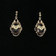 These are Victorian style filigree drops with a gold brass bat hang from a gold filled post earring. The delicate, gold plated, open work earrings have a .5 inch purple cut glass stone. They are very lightweight and drop to about 1.25 inches.  The tiny bat added to the circa 1950's earrings measure a little under .5 inch. This piece of jewelry is sent in a bubble pack envelope via US postal service, first class mail with insurance and packed in a gift box. International rate is $23. Buyers are responsible for any customs and import taxes that may apply. These fees are taken by your country, not Etsy. Necromance is not responsible for delays due to customs. Victorian Gothic Earrings, Gold Gothic Jewelry, 1950s Earrings, Work Earrings, Bat Jewelry, Bubble Pack, Earrings Gothic, Vintage Earring, Bat Earrings