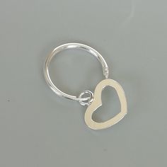 A PAIR of sterling silver hoops. Comes with a detachable heart charm. The charm is multipurpose and can be used with a neck or bracelet chain too. Dimension: Hoop- 14 x 1.5 mm Heart: 11 x 11 mm Price listed is for a PAIR of hoops. These earrings are made of 925 hypoallergenic sterling silver and comes with a 925 stamp. Can be packaged in a gift box. I can include a personal message from you if needed You are welcome to contact me at... bhavnakwintra1956@gmail.com For more beautiful pieces from m Silver Hoop Earrings With Heart Charm, Everyday Hoop Septum Ring In Sterling Silver, Sterling Silver Hoop Septum Ring, Everyday Sterling Silver Hoop Septum Ring, Minimalist Jewelry With Heart Charm In Small Hoop, Minimalist Jewelry With Heart Charm On Small Hoop, Minimalist Small Hoop Jewelry With Heart Charm, Silver Huggie Septum Ring For Everyday, Silver Hoop Septum Ring For Anniversary