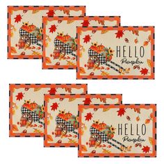 four placemats with autumn leaves and pumpkins on them, each featuring an image of a wagon