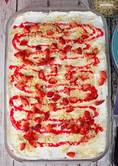 strawberry shortbread with cream and strawberries in a glass dish on a wooden table