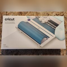 an instruction manual for the cricut machine is displayed on a marble countertop