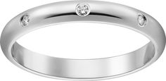 a white gold wedding ring with a single diamond