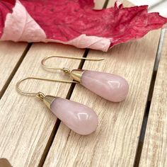 Rose Quartz dangle gold earrings, Gemstone teardrop earrings, Beaded stone statement earrings Long dangle teardrop earrings featuring gorgeous Rose Quartz teardrops made with 14 K gold filled ear wires or lever back.           The Rose Quartz teardrop is about 1.18" ( 30 mm ) long and the largest part of the teardrop is about 0.4" ( 10 mm ) wide. These earrings can be made with 14 K gold filled ear wires or lever backs ( as shown in the pictures ) and the earrings full length is about 1.6" ( 40 Pink Gemstone Teardrop Earrings, Pink Teardrop Earrings With Natural Stones, Pink Teardrop Crystal Earrings, Rose Quartz Teardrop Earrings For Gift, Rose Gold Rose Quartz Drop Earrings, Rose Gold Drop Earrings With Gemstones, Elegant Teardrop Rose Quartz Earrings, Rose Gold Teardrop Crystal Earrings, Lock Charm Necklace