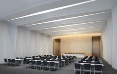 an empty room with rows of black and white chairs