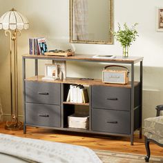 a room with a bed, mirror and dresser in it's centerpieces