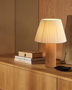 a lamp sitting on top of a wooden dresser