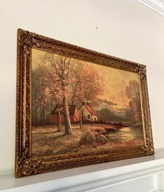 a painting hanging on the wall above a fireplace