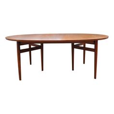 an oval wooden table with two leaves on the top and one leaf at the bottom