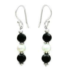 India's Narayani designs these fabulous earrings. Crafted by hand with iridescent pearls in stark contrast with black onyx they feature the elegant drama of sterling silver accents. .925 Sterling silver Black Sterling Silver Pearl Earrings For Formal Occasions, Black Dangle Pearl Earrings For Formal Occasions, Black Sterling Silver Jewelry With Pearl Drop, Black Dangle Pearl Drop Earrings, Black Pearl Drop Dangle Earrings, Black Sterling Silver Pearl Earrings Gift, Black Pearl Sterling Silver Earrings As Gift, Elegant Black Pearl Drop Earrings, Black Dangle Pearl Earrings