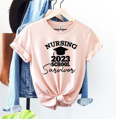 a pink shirt with the words nursing school survivor on it and a pair of jeans