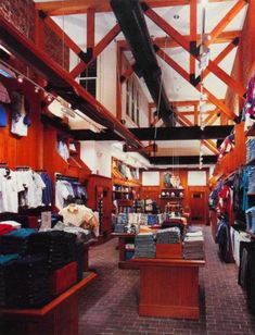 the inside of a clothing store with clothes on display