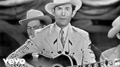 two men in cowboy hats playing guitar and singing