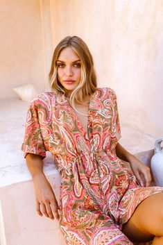 Floaty and feminine, The Cecile Kaftan in Barcelona Paisley is your next stunning staple for the season. Wear over your Baiia bikini or wrap suit as a classic beach cover-up or effortlessly elevate this summer dress favourite with a pair of strappy sandals or heels, your favourite accessories, and a statement bag. Made from a luxurious silk-like fabric crafted from recycled plastics, this pink paisley midi dress is soft to touch and lightly drapes over your stunning curves to flatter in all the V-neck Beach Cover-up Dress With Tie Waist, V-neck Beach Dress With Tie Waist For Vacation, V-neck Swimwear With Tie Waist For Summer, One-piece Beachwear Dress For Summer Parties, Spring V-neck Swimwear With Tie Waist, One-piece Beach Dress For Summer Parties, Chic V-neck Beach Dress For Summer Outings, Beachwear Dress With Surplice Neckline For Vacation, Flowy V-neck Swimwear For Vacation