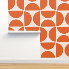 an orange and white wallpaper with circles on it in a room next to a door