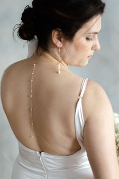 If you're looking for a statement for your big day, look no further. Our Pearl Back Drop Necklace features a 5" front drop and a 7" back drop, adorned with hand fastened freshwater pearls to finish the look. This piece is classic, elegant, and sure to make you like the beautiful bride you are on your special day. Includes 10 freshwater pearls + 16" neck length of 14k gold-filled cable cha Elegant Lariat Backdrop Necklace For Wedding, Pearl Bridal Necklace For Wedding, Adjustable Single Strand Pearl Necklace For Wedding, Delicate Single Strand Bridal Necklace For Wedding, Elegant Single Strand Bridal Necklace For Wedding, Adjustable Pearl Drop Bridal Necklace For Formal Events, Gold Pearl Chain Backdrop Necklace For Wedding, Bridal Pearl Necklace For Wedding, Gold Backdrop Necklace With Pearl Chain For Wedding