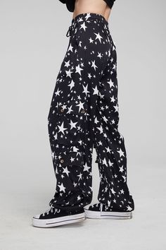 A must-have for any wardrobe, our Billyy Walk of Fame Trousers offer a stylish blend of aesthetics and comfort with their slightly stretchy viscose fabric, cargo pockets, drawstring waist, and star print. Perfectly coordinating with our matching blouse, these classic trousers in black with white stars guarantee a dashing ensemble of timeless appeal. Model is 5'9" and wearing size small Fabric Content: 97% Viscose 3% Spandex Imported Style: CW9781-WLKFME Classic Trousers, White Stars, Walk Of Fame, Viscose Fabric, Star Print, Drawstring Waist, Must Haves, Trousers, Spandex