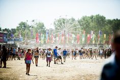 a crowd of people walking around a carnival