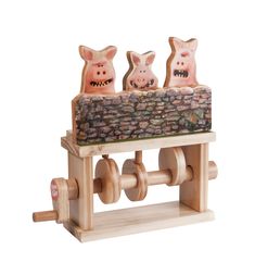 three pigs are sitting on top of a wooden machine