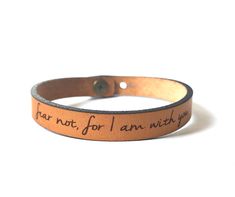 "Taking a short break to enjoy time with family. Our shop remains open with processing times extended. Thank you! Be Inspired all Day. Jewelry with meaning. Skinny Full Grain Leather Bracelet with Engraved with \"fear not, for I am with you\". Makes a wonderful gift reminder to someone you love! Or choose a different word or customize one with your own words! (Choose custom & add your words in the personalization box.) This Classic style Leather Bracelet is perfect for stacking with each oth Custom Engraved Bracelet, Leather Engraved, Blessed Assurance, Enchanted Castle, Leather Bra, Leather Engraving, Message Bracelet, Enjoy Time, Crafting Materials