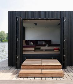 an open door on the side of a wooden dock