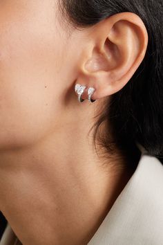 Repossi's single earring is part of 'Serti Sur Vide', which aligns with the jeweler's avant-garde collection. It's handcrafted from shining 18-karat white gold and set with a modern trio of pear-cut pavé diamonds. The sparkling design sculpts your lobe as if it's artistically floating. Formal Sterling Silver Pierced Huggie Earrings, Luxury White Gold Single Diamond Earring, Luxury Single White Gold Diamond Earring, Modern Diamond White Huggie Earrings, White Gold Jewelry With Matching Earrings For Everyday Luxury, Modern Diamond White Huggie Jewelry, Modern White Gold Huggie Earrings With Cubic Zirconia, Formal Teardrop Sterling Silver Huggie Earrings, Everyday Luxury White Gold Jewelry With Matching Earrings