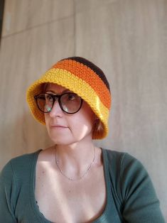 Crocheted winter woman bucket hat, made with soft yarn 25 % wool and 75% acrylic. Three coulor crochet bucket hat brown, orange, yellow. Size : US 6 7/8 - 7 ; S - M Head diameter 54 -56 cm. Free shipping on orders $35 and up to US buyers Retro Yarn Beanie Hat, Yellow Yarn Crochet Hat, Retro Winter Crochet Hat Made Of Yarn, Trendy Brown Knitted Hat, Handmade Retro Crochet Hat For Winter, Retro Handmade Crochet Hat For Winter, Hand Knitted Winter Bucket Hat, Handmade Yellow Brimmed Bucket Hat, Yellow Crochet Bucket Hat One Size