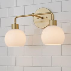 two light fixtures on the wall in a bathroom