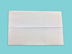 a white envelope on a blue background with clippings to the front and bottom