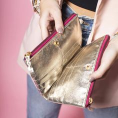 Add some color to your wallet game with this metallic leather wallet! With its multi-colored design, it's sure to make a statement. But it's not just for show - it also has plenty of room for all your cards and cash. So brighten up your daily routine with this fun and functional wallet. 7.5" L X 4.75" W X 1.25" W Trendy Gold Rectangular Wallet, Gold Leather Wallet With Card Slots, Modern Gold Wallets For Everyday, Gold Wallets With Card Slots For Travel, Gold Bifold Coin Purse For Everyday Use, Gold Travel Wallets With Card Slots, Gold Bifold Coin Purse With Card Slots, Gold Clutch With Card Slots, Modern Gold Wallets With Rfid Blocking