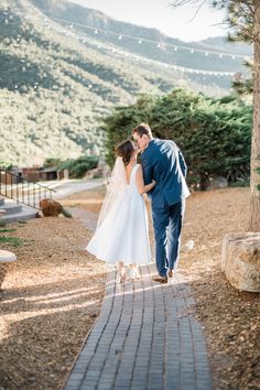 Capturing a tender moment between newlyweds amidst golden afternoon light 🧡. The bride's timeless wedding dress and the groom's stylish dark blue suit add a touch of elegance to this serene outdoor setting. Perfect inspiration for those envisioning a wildflower wedding theme or intimate engagement photos! 🌸👰🤵✨ #weddingideas #engagementphotos #timelessweddingdress #wildflowerweddingtheme #backyardwedding** Enchanting Backyard, Golden Afternoon, Intimate Engagement, Dark Blue Suit, All Inclusive Wedding Packages, Afternoon Light, Timeless Wedding Dress, Las Vegas Elopement