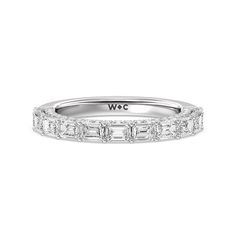 a white gold wedding band with baguets and diamonds on the sides, set in 18k white gold