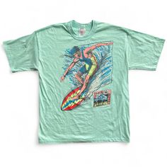 Overview: Vintage 80s Surfing T-Shirt In A Nicely Faded Sea Foam Green Color With Bold Surfer Graphics And Club Pacific, Beach Club 1988 Hit In The Bottom Corner, Designed By J Oppenheim. Single-Stitched Sleeves And Bottom Hem. Made In The Usa. Size: Tagged Adult Large, L "Oversize"- Which For An 80s Fit Really Means It Fits Like You Might Expect A Vintage 90s Large To Fit- Please See Measurements Below For Best Fit. This Is A Vintage Preloved Tee In Very Good Condition With Light Pilling, Fadin Blue Summer Shirt With Front Print, Blue Shirt With Front Print For Summer, Blue Short Sleeve Tops For Surfing, Relaxed Fit Blue Tops For Surfing, Retro Green Tops With Front Print, Blue Relaxed Fit Tops For Surfing, Blue Beach Top With Front Print, Blue Surfing Tops With Screen Print, Vintage Surf Shirt