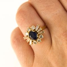 Here is a 18K Yellow Gold ring with a centre Sapphire and in the Gallery there are 6 Round Diamonds and 6 Tapered Baguette Diamonds. Condition: Used (Very Good) Weight: 3.8 grams UK Ring Size: J Please contact for quick resizing! Tested as: 18K Yellow Gold Box: New Gift Box Comments: These Diamonds/Gemstones have not been certified by a laboratory, they have been graded by our own qualified gemologists as fairly and as accurately as possible. Postage: This Ring will be posted via Royal Mail Special Delivery, and should be with you within 3 days of your order. Free postage to the UK! We are a trusted company in Hatton Gardens London, with a wide range stock of high-end watches and fine jewellery. Have a look at our other listings or message us any interest in any item you may be looking for Yellow Gold Cluster Ring With 17 Jewels, Gold Cluster Ring With 17 Diamonds, Yellow Gold Cluster Ring With Brilliant And Baguette Cut, Yellow Gold Cluster Ring With Baguette And Brilliant Cut, Exquisite Gold Sapphire Ring With Prong Setting, Heirloom Gold Cluster Ring With Sapphire, Heirloom Gold Sapphire Cluster Ring, Heirloom Sapphire Cluster Ring In Gold, Cluster Yellow Gold Hallmarked Rings