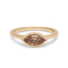 A marquise shape bezel set champagne diamond set in yellow gold. East West Marquise, Bezel Set Ring, Gold Champagne, Aquamarine Jewelry, Marquise Diamond, Champagne Diamond, Bezel Diamond, East West, Champagne Gold