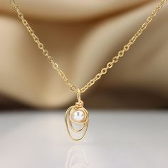 A dainty and unique white pearl necklace Set with a 4 mm fresh water pearl ☆ WHY THIS PIECE OF J E W E L R Y IS AWESOME! ☆ * Hand finished and made from high quality raw materials * Long lasting beauty & Timeless design * Unique fonts, Highest quality finish and detailing. MATERIALS * Made in 14K Gold plated or Sterling silver. * High quality chain that is exactly the right size for your name (Delicate and subtle) ♡ WRAPPING ♡ * All 23 Summers jewels arrive in a cute pouch or gift box so the Wire Wrapped Pearl Necklace In Gold, Delicate Gold Wire-wrapped Pearl Necklace, Delicate Gold Wire Wrapped Pearl Necklace, Dainty Pearl Necklace With Wire Wrapped Detail, Dainty Pearl Necklace With Wire Wrapping, Dainty Pearl Wire Wrapped Necklaces, Delicate Gold Wire Wrapped Necklaces, Delicate Gold Wire Wrapped Necklace, Gold Wire Wrapped Pearl Necklace For Wedding