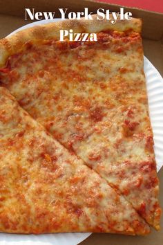 two slices of pizza sitting on top of a white paper plate in a cardboard box