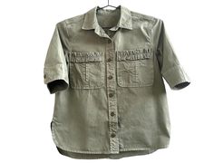 Vintage Cotton Canvas Faded Army Green Button Up Short Sleeve Shirt Size S Women  Measurements:  Chest: 36 inches Shoulders at the back: 16 inches Sleeve length: 11 1/2 inches Length of the shirt at the back: 22 1/2 inches Material: Cotton canvas This item is vintage. Used. Good vintage condition. Utility Style Khaki Tops With Buttons, Khaki Utility Tops With Buttons, Khaki Utility Top With Button Closure, Utility Collared Top With Buttons, Summer Utility Button-up Top, Utility Tops With Collared Roll-up Sleeves, Khaki Button-up Blouse With Pockets, Utility Tops With Roll-up Sleeves And Collar, Utility Tops With Roll-up Sleeves And Collared Shape