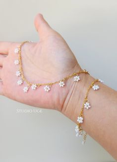 White Dainty Flower Shaped Beaded Bracelets, Delicate White Flower Beaded Bracelets, Delicate White Flower Shaped Beaded Bracelets, White Dainty Beaded Bracelet With Flower Charm, Dainty White Beaded Bracelet With Flower Charm, Delicate White Flower Bracelets, Dainty White Beaded Bracelets With Adjustable Chain, Dainty Flower Shaped Jewelry With Tiny Beads, Dainty Flower Jewelry With Tiny Beads