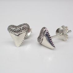 These recycled sterling silver stud earrings are meticulously crafted from recycled sterling silver, embodying our commitment to environmental consciousness without compromising style. They measure 9 mm long and come with a sterling silver back. Shark teeth hold symbolic significance representing strength, resilience, and adaptability. These razor-sharp artifacts are often associated with the primal power of sharks, creatures known for their predatory prowess and survival instincts. In various c White Gold Sterling Silver Plug Earrings, Sterling Silver White Gold Plug Earrings, Sterling Silver White Gold Plug Earrings For Gift, White Gold Sterling Silver Plug Earrings As Gift, Polished Sterling Silver Earrings As A Gift, Hypoallergenic White Gold Plug Earrings In Sterling Silver, Silver Sterling Plug Earrings For Anniversary, Silver Shark, Environmental Consciousness