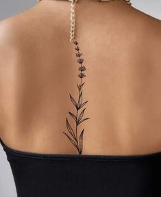 the back of a woman's neck with flowers on it