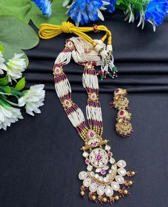 Your traditional attire with this exquisite Heer Rajwadi Kundan long Meenakari Necklace with Jhumka Earring set, featuring a stunning combination of gold and pink hues. Perfect for special occasions, this set exudes elegance and sophistication, making it a must-have addition to your jewelry collection. Style & Look: Elevate your style with the Heer Rajwadi Kundan long Meenakari necklace, beautifully complemented by Jhumka earrings. This exquisite set combines the regal allure of Rajwadi design w Luxury Festive Meenakari Necklaces, Traditional Jewelry Sets With Cutdana For Festive Occasions, Diwali Chandbali Jewelry Sets With Latkans, Traditional Festive Jewelry Sets With Cutdana, Temple Jewelry Sets With Chandbali Shape And Latkans, Temple Jewelry Sets With Chandbali Latkans, Traditional Meenakari Jewelry Sets For Festivals, Festive Jewelry Sets With Latkans For Eid, Festive Chandbali Jewelry Sets For Puja