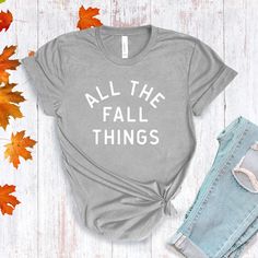 All The Fall Things in a modern font graphic on front in cream or multi Fall colors. Youth Sizes S-XL (unisex sizing) Toddler Sizes 2T, 3T, 4T To view All The Fall Things Adult T-shirts click here.To view All The Fall Things Baby Bodysuit click here.Bella + Canvas4.2 oz. Airlume combed and ring-spun cottonPre-shrunkFor a more relaxed fit, size up! Trendy Screen Print T-shirt For Fall, Fall Graphic Print T-shirt, Gray Slogan T-shirt For Spring, Spring Gray T-shirt With Slogan, Fall Soft-washed Tri-blend T-shirt, Soft-washed Tri-blend Fall T-shirt, Tri-blend Graphic Tee For Fall, Fall Graphic Tee Soft-washed, Gray Text Print T-shirt For Fall