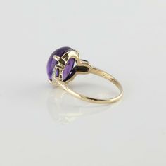 Vintage 10K Yellow Gold Amethyst Cabochon and Diamond Ring, 10 x 12mm oval medium dark amethyst high dome cabochon, 6 diamonds set in white gold, tulip shapes to sides, 7/16 inch across, polished engraved designs mid shank, Ring size 7.25, Circa 1950, 3 grams SKU# BB285R04 This listing contains photographs of the actual item you will receive. Our items are in excellent condition with little or no signs of wear and many are one of a kind pre-owned estate finds. Please look closely at the pictures Gold Coin Ring, Dark Amethyst, Sparkly Ring, Gold Diamond Band, Amethyst Gem, Coin Ring, Purple Band, Fine Jewelry Designers, Boston Ma