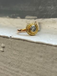 a gold ring sitting on top of a white surface